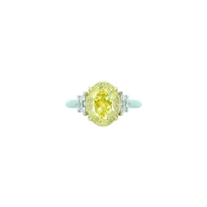 18 Karat White and Yellow Gold Three Stone Ring with Oval Cut Fancy Yellow Diamond and white Half moon diamonds