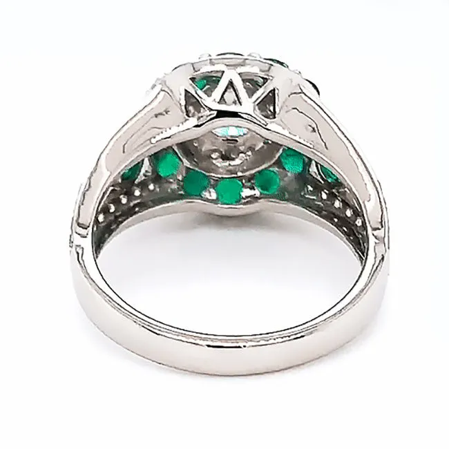 Platinum engagement ring with diamonds and emeralds